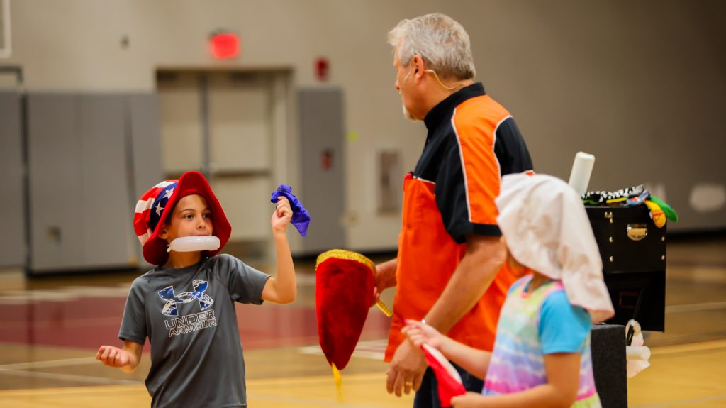 a special camp guest that's hosting a fun activity for campers in a gymnasium