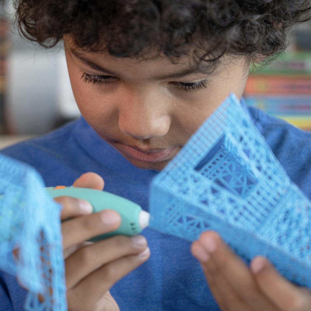a young boy creating a 3D structure as a way to explore his passions and interests